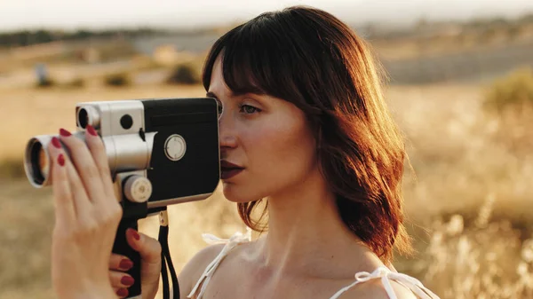 Close up of a woman with a vintage movie camera