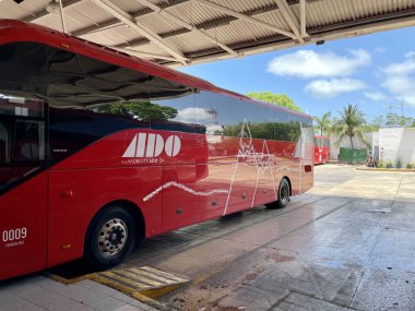 Cancun, Mexico - May 7, 2022: Red bus of the Mexican company ADO - Autobuses de Oriente. ADO is serving roughly the eastern half of the country.