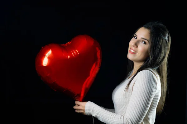 Young Girl Holding Heart Shaped Balloon Smiling Foreground Black Background — Stock Photo, Image