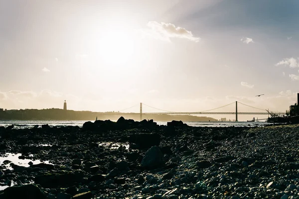 Solnedgång Stranden Floden Tagus Med April Bron Och Statyn Kristus — Stockfoto