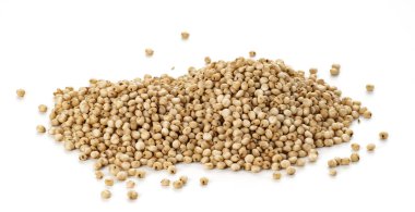 pile of raw unhulled Sorghum grains closeup on white background clipart