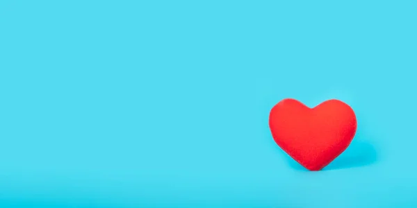 Red heart on blue background, health care, love, organ donation, family insurance,CSR,world heart day, world health day, praying concept.