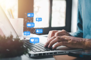 Businessman using laptop computer with social media icon, Marketing concept.	