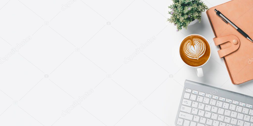 Office desk with computer, Pen, Notebook and Cup of coffee on white background, Top view with copy space, Mock up.