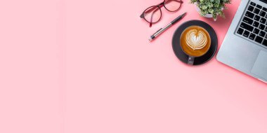 Office desk with computer, Pen, mouse, Cup of coffee on pink background, Top view with copy space, Mock up.	