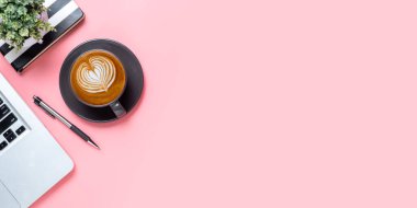 Office desk with computer, Pen, mouse, notebook, Cup of coffee on blue background, Top view with copy space, Mock up.	