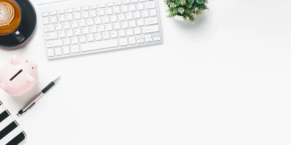 Office desk with keyboard computer, Pen, notebook, Cup of coffee on white background, Top view with copy space, Mock up.