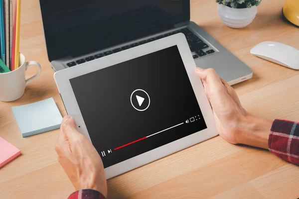 Video streaming on internet, Person watching online movie or TV series on laptop computer, Concept about subscription based live digital stream.