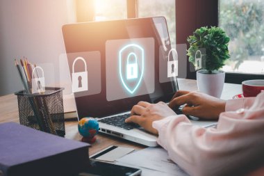 Cyber security concept, Business woman hand using computer with padlock security interface to protect data on desk, internet security.	