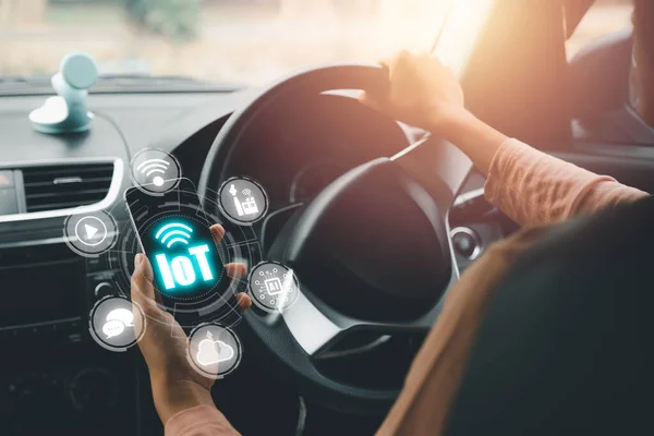 IOT Internet of things, Person hand using smart phone on car with VR screen Internet of things icon background, Digital transformation, Modern technology concept..