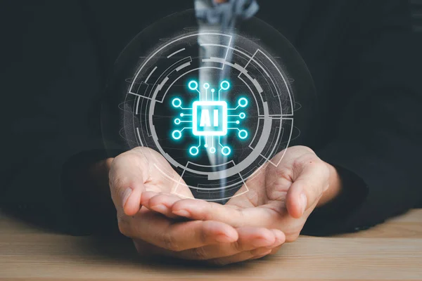 Artificial Intelligence AI, Person hand holding holographic brain Artificial Intelligence (AI) icon from the screen, Internet of Things IoT concept.