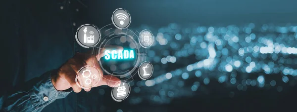 SCADA Supervisory control and data acquisition technology concept, Person hand pointing on SCADA icon on virtual screen.