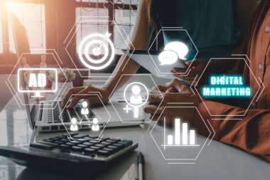 Digital marketing technology concept, Businessteam discussing data on office desk with VR screen digital marketing icon on office desk, Internet, Online, Search Engine Optimisation.	