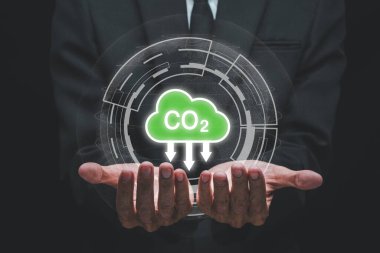 Reduce CO2 emission concept, Person hand holding with VR screen CO2 icon, Sustainable development and green business based on renewable energy, electric transport..	