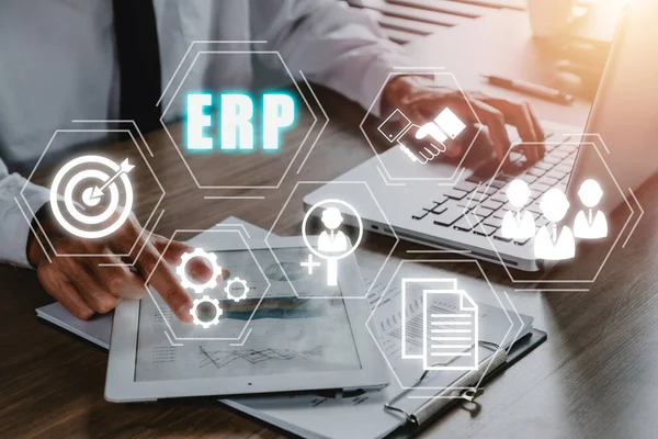 Enterprise Resource Planning ERP, document management concept with icons on virtual screen, Businessman working on digital tablet with icons on virtual screen on office desk.