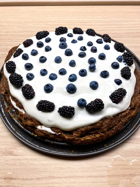 Gluten free cacao cake from zucchini with curd and blackberries.