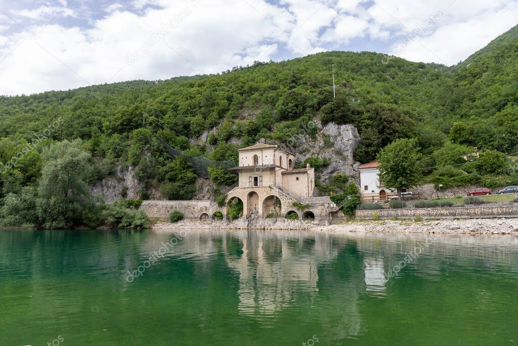 Scanno lake in Abruzzo in Italy in summer with the Church of the Madonna del Lago in the background.