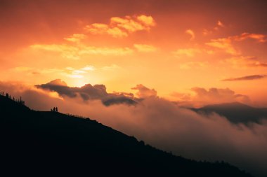 Beautiful sunset over the silhouette of the mountain with clouds. Dramatic sunset sky cloudscape. Freedom, motivation concept. Copy space