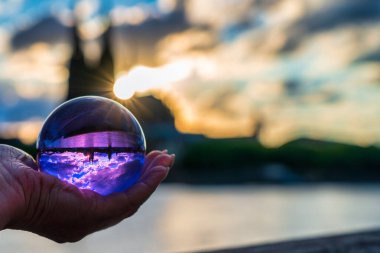 Close up of lensball at sunset in Cologne with Cologne Cathedral in background, Germany.