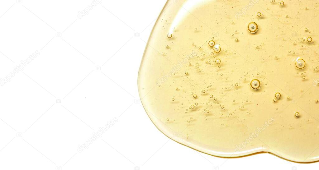big size macro photo yellow gel texture with bubbles. Oil for skin. Clear cosmetic liquid gel swatch isolated on white background, banner format isolated with free space for text