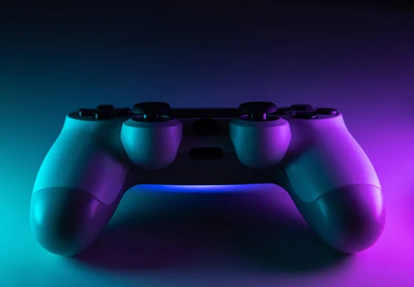 Controlador de juego, gamepad sobre fondo de neón azul y morado. macro, primer plano — Foto de Stock