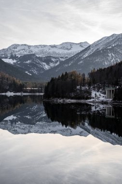 Mountains and Building reflecting in a calm mirror lake