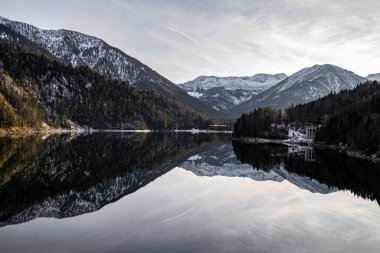 Mountains and Building reflecting in a calm mirror lake