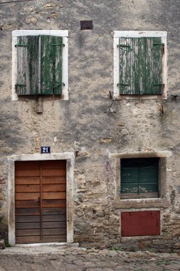 Hırvatistan 'ın Akdeniz kentinde eski bir kasabanın ön cephesindeki eski ahşap kapı ve pencereler