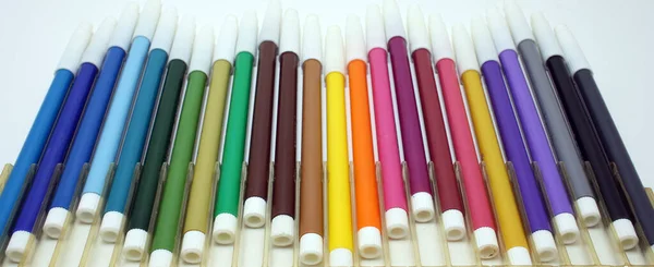 markers of different colours on a white background