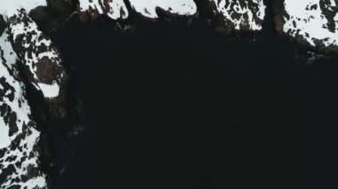 İnsansız hava aracı Kuzey Buz Denizi kıyısında uçuyor, kayalar karla kaplı. Okyanusun kara suları İskandinavya 'nın kayalık kıyılarını ya da Kuzey Amerika' yı sular. Karlı Grönland