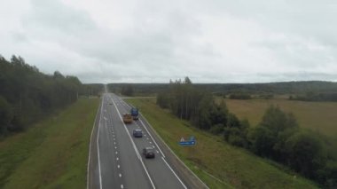 Drone yoğun bir otoyol boyunca uçuyor, arabalar, kamyonlar ve arabalar dört şeritli bir otoyol boyunca derede ilerliyor. Zor yoldan uzaklaşmak için kavşağa park etmiş arabalar.