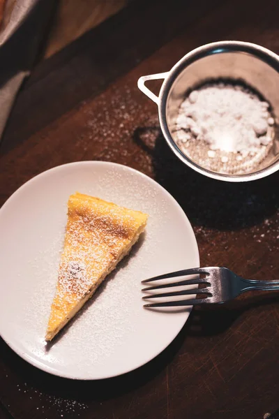 slice of ricotta cheese pie, pine nuts and chocolate chips. breakfast with a slice of cake.