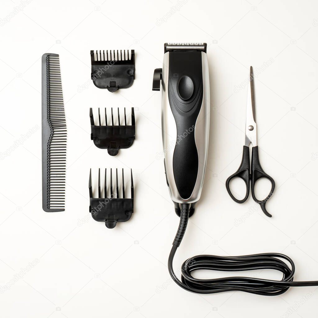 electric hair clipper with accessories on a white background