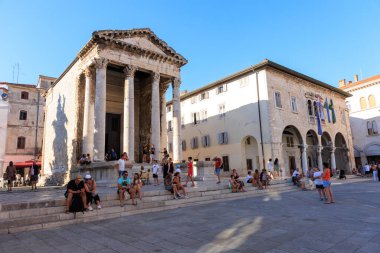 Pula Croatia. July 30, 2022 view of the town hall building and the roman temple in Pula