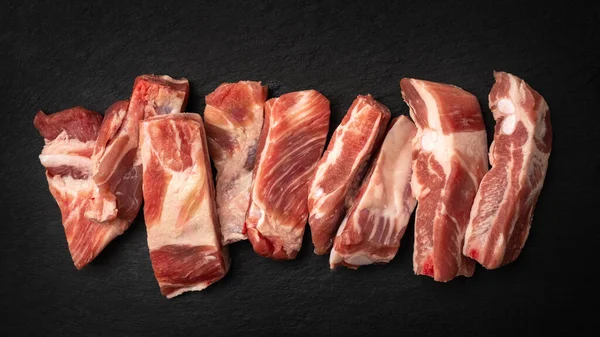 pieces of pork cut on black background