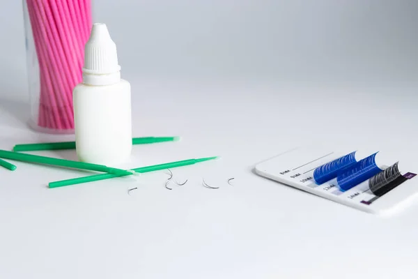 Artificial eyelashes in black and blue on a white background