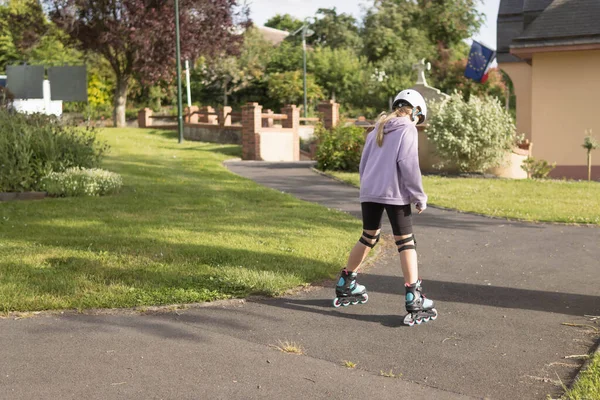 Child Learns Roller Skate Park Dressed Girl Lilac Sweater Black — Fotografia de Stock