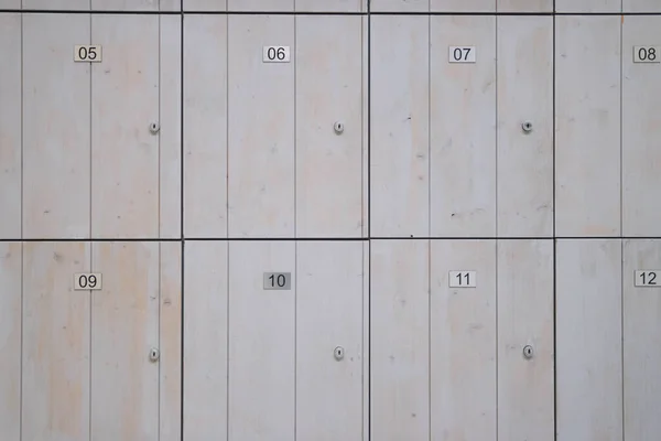 brown wooden lockers for storing things in the store. Lockers with numbers and a lock close-up. High quality photo