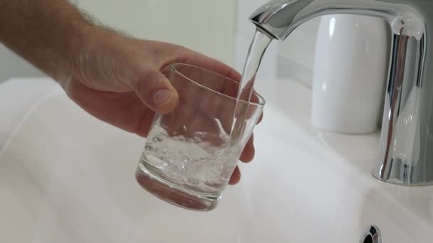 Man Draws Water Glass Metal Tap Mans Hand Isolated Light — Stok Video