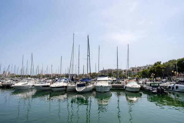 Sleek and modern sailboats and motor boats crammed to a pier in a central marina in Antibes, France. Summer Vacation, Cruise, Recreation, Sport, Regatta, Leisure, Service, Tourism