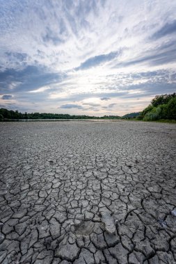 Drying up lake in Bavaria Germany from extreme weather and summer heatwave, climate change and drought