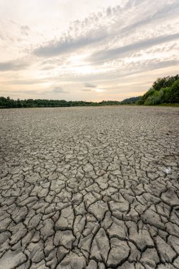 Dry lake in Bavaria Germany. Drought and climate change, landscape of cracked earth after lake has dried up in summer. Water crisis an impact of global warming.