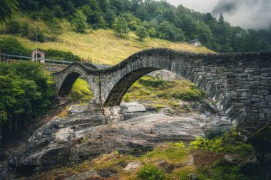 View of Lavertezzo village, famous tourist destination - An old Swiss village with double arch bridge on Ponte dei Salti with waterfall, Lavertezzo, Verzasca Valley