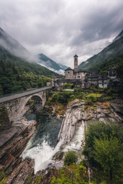 View of Lavertezzo village, famous tourist destination - An old Swiss village with double arch bridge on Ponte dei Salti with waterfall, Lavertezzo, Verzasca Valley