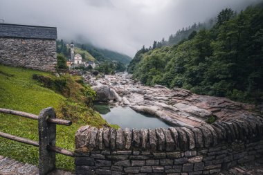 View of Lavertezzo village, famous tourist destination - An old Swiss village with double arch bridge on Ponte dei Salti with waterfall, Lavertezzo, Verzasca Valley
