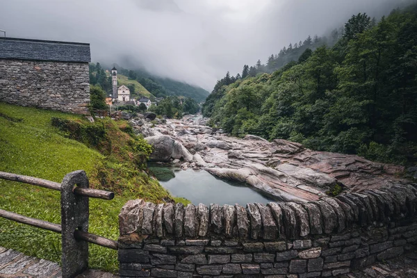 View of Lavertezzo village, famous tourist destination - An old Swiss village with double arch bridge on Ponte dei Salti with waterfall, Lavertezzo, Verzasca Valley