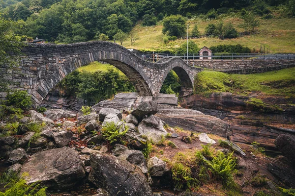 View of Lavertezzo village, famous tourist destination - An old Swiss village with double arch bridge on Ponte dei Salti with waterfall, Lavertezzo, Verzasca Valley