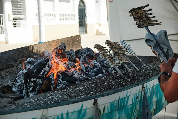 İspanya, Malaga 'da sardalya şişi pişirmek için alevli közler.