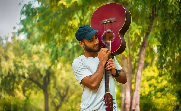 Kırmızı gitar görüntüsü olan adam