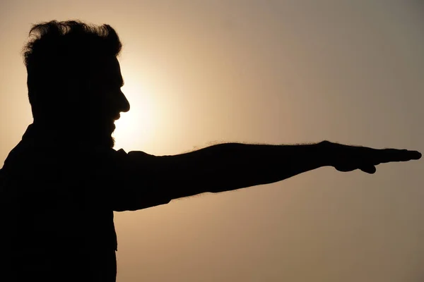 A man silhouettes near sun light, Oath taking image